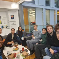 PhD researchers and their student shadows having lunch in the Informatics building