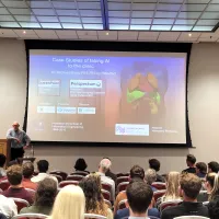 Michael Brady presenting in front of audience at the UKRI AI CDTs in Healthcare Conference 