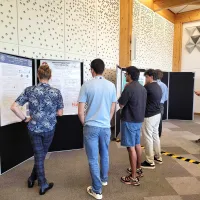 CDT students gathered around our students research posters