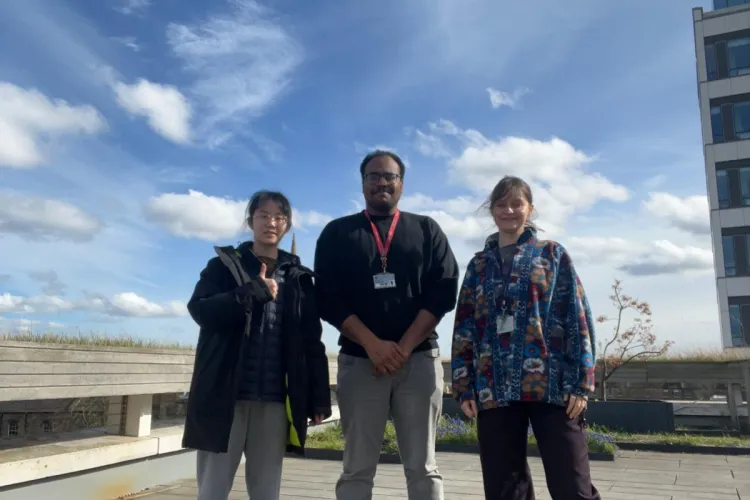 PhD researcher and her student shadows on the School of Informatics terrace