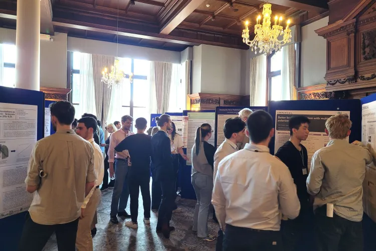 Attendees in discussions during the poster session at the UKRI AI CDTs in Healthcare Conference 2025
