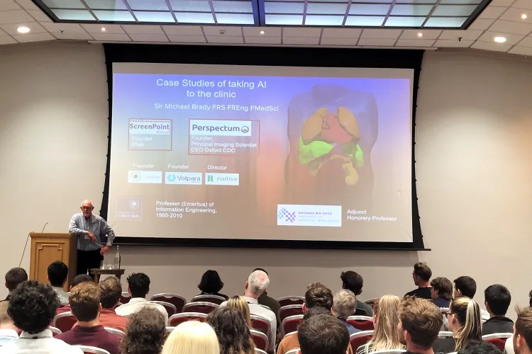 Michael Brady presenting in front of audience at the UKRI AI CDTs in Healthcare Conference 