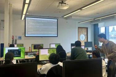 Our students teaching a class of secondary school students in a computer lab