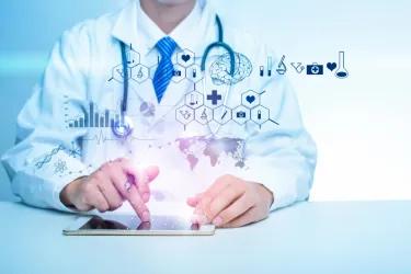 Doctor using a tablet with digital medical icons and data graphics floating above it, representing biomedical informatics and digital healthcare.