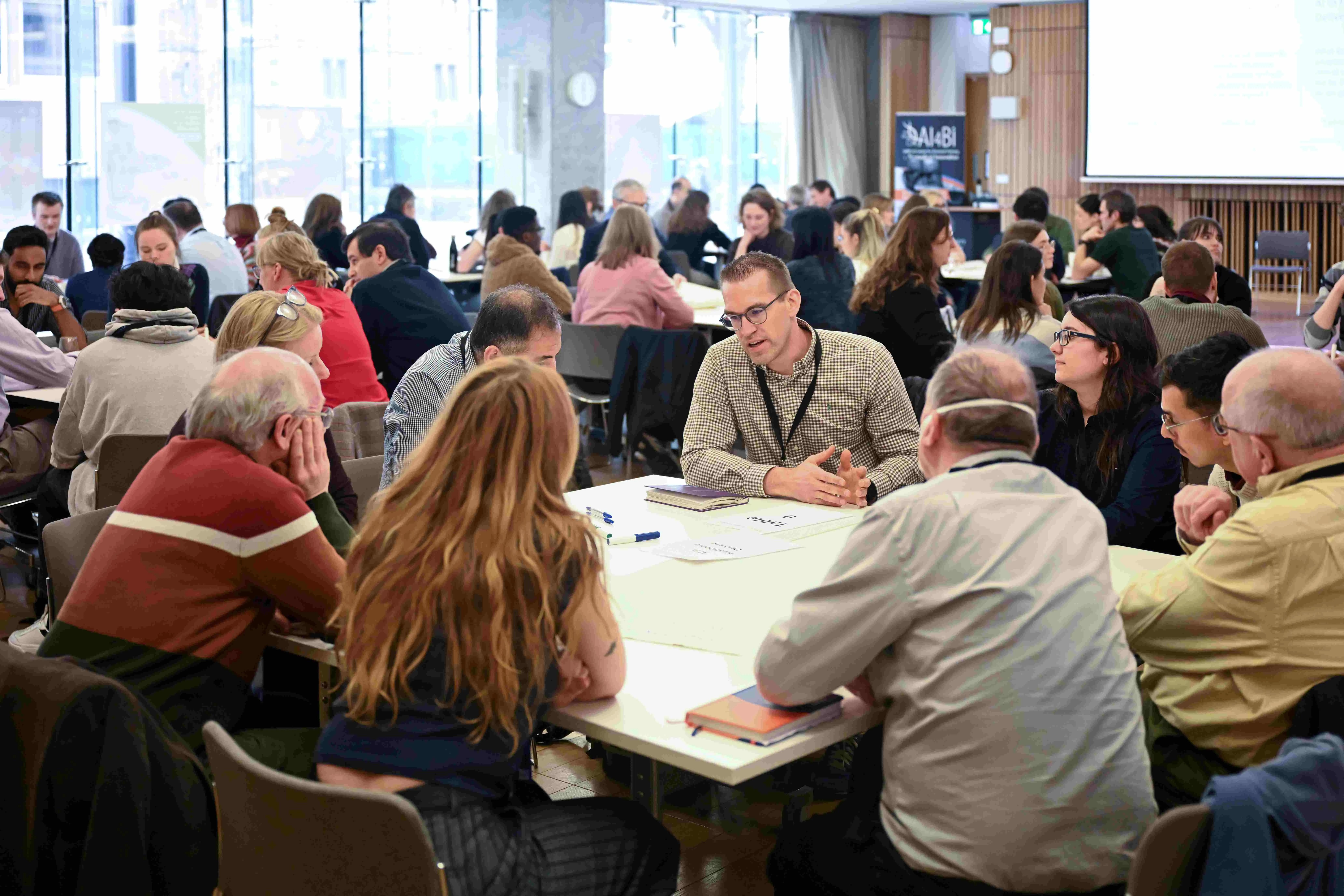 Students and academics in group discussions at our annual AI4BI Forum