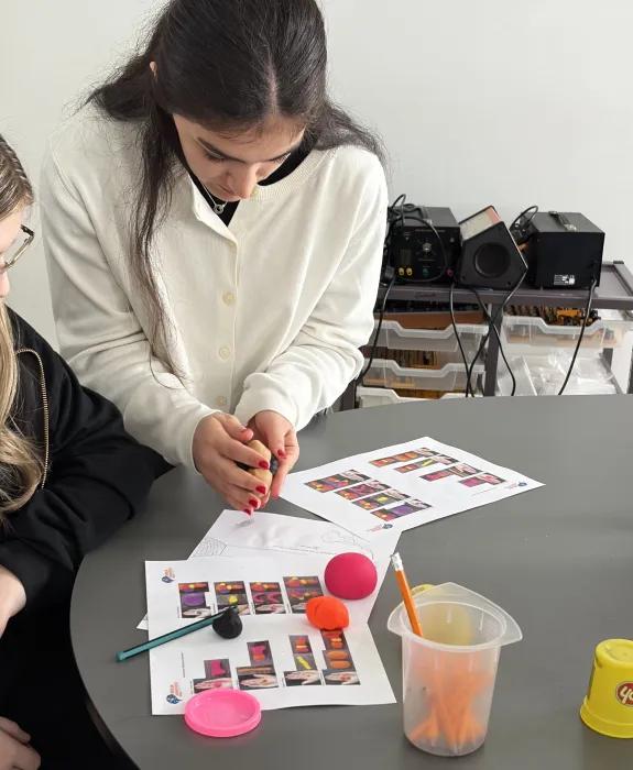 Lachin working with one of the school students