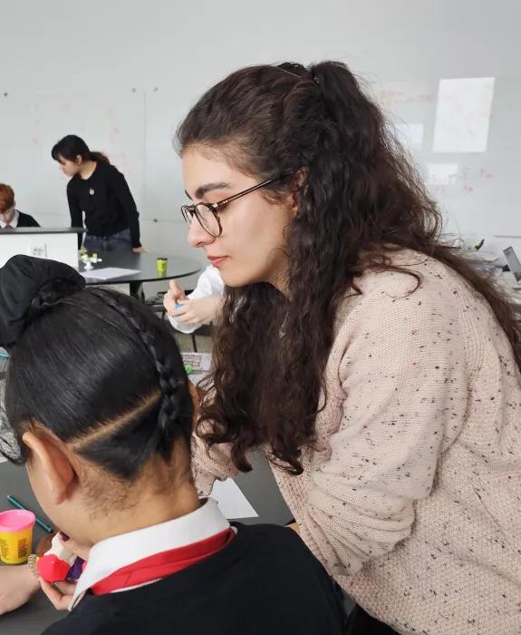 Nikoo working with one of the school students